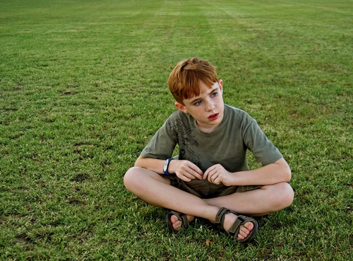 Autistic boy on grass